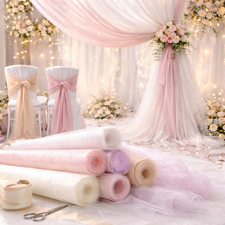 Wedding draping fabric including organza and tulle rolls used for venue decoration and ceremony backdrops.