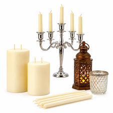 Ivory candles, candle holders and a lantern on a white background
